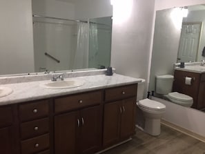 Private bathroom in master bedroom with double sink