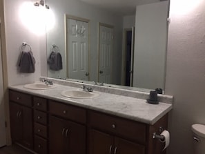 Private bathroom in master bedroom with double sink