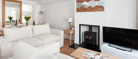 The living room which has two double sofa beds and leads to the dining area