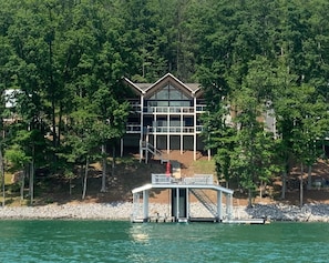 View from the lake with 2 story dock with 2 boat slips and 2 wave runner slips
