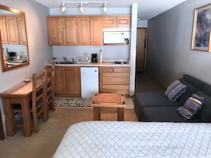 Studio with kitchen, queen bed, and convertible sofa to queen bed