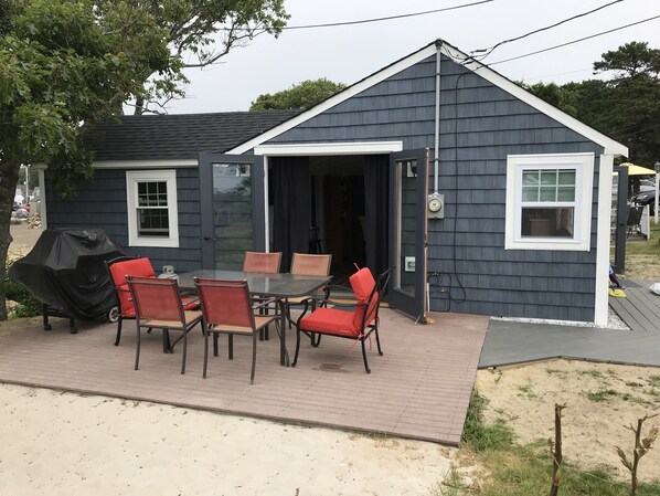 nice deck with open french doors into the living room