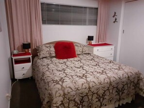 Queen size bed with dimple topper pad. Touch lamps and drawer space.
