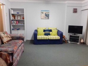 Lounge has a pull-out-sofa bed, selection of books, Scrabble and a pack of cards