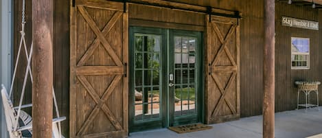 French doors entering barn with barn doors on top