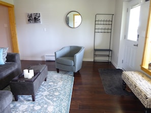 Living room with entrance door on the right.