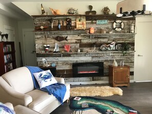 Fun ocean themed decor and electric fireplace.