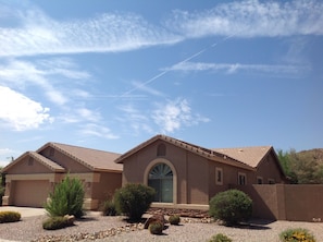 Front view of home with Mountain and Golf course behind.