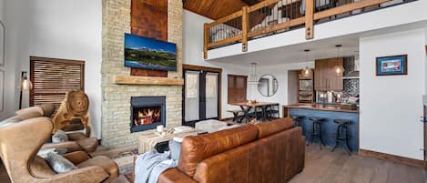 Living area with 25 foot tall fireplace and 50 inch smart TV