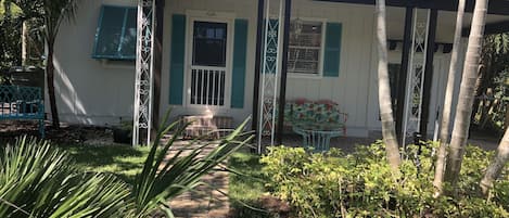 Relax on the front porch and enjoy being surrounded by lush foliage