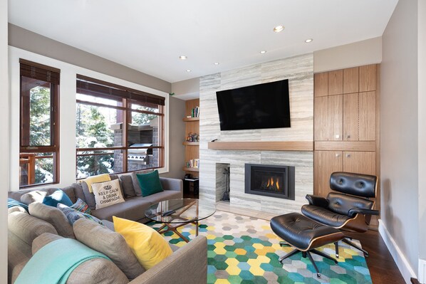 Living room with TV, gas fireplace, and comfy couches