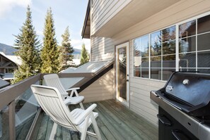 Deck features a BBQ and lounge chairs