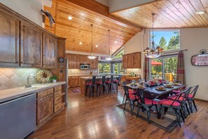 View of dining room, kitchen, and wet bar