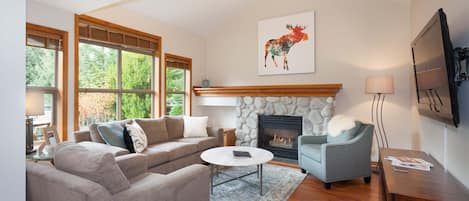 Spacious living room with big screen TV.