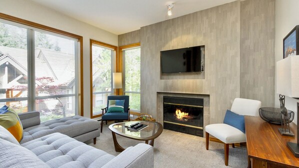 Comfortable sectional sofa with fireplace and TV
