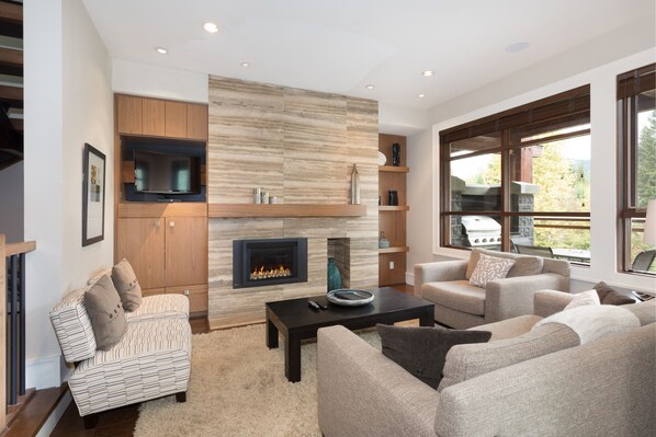 Living room with gas fireplace and TV