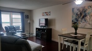 living room and dining area showing 50 in. Roku TV