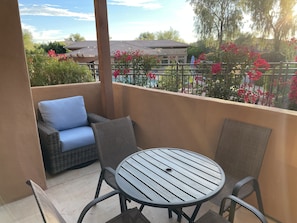 Large patio with seating for 4 and 2 comfy wicker chairs for lounging
