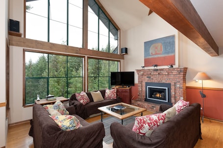 Cozy living room with floor to ceiling windows
