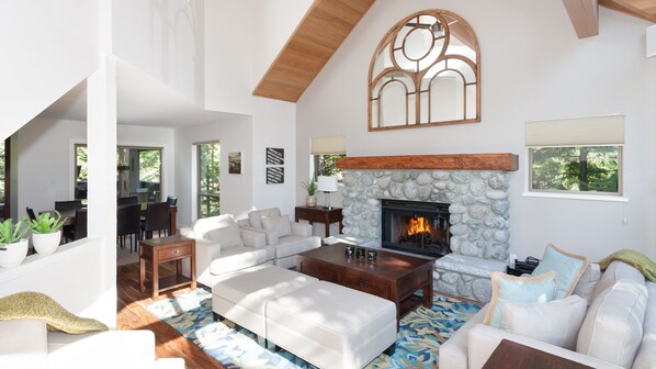 Spacious living room with vaulted ceiling and fireplace