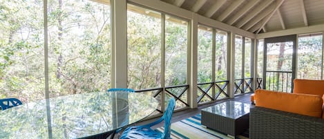 Enjoy the spacious screened porch surrounded by lush foliage. 
