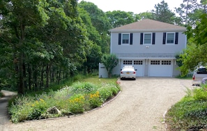 Our driveway and end of house. Apartment entrance is past white fence on left.