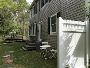 Private entrance to apartment, w/ table, chairs, grill. Lock on fence for bikes.