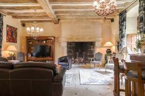 Living room with large sitting area, TV and mini bar