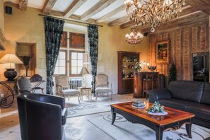 Living room with large sitting area, TV and mini bar