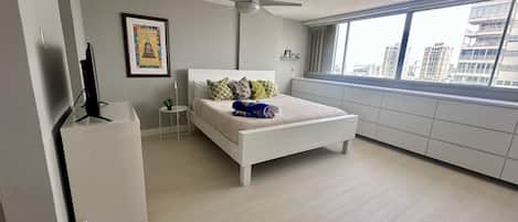 Ample sleeping area with king bed and many drawers to keep things organized.