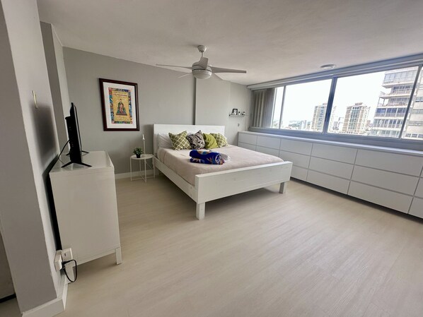 Ample sleeping area with king bed and many drawers to keep things organized.