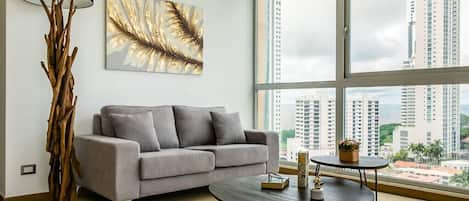 Living room with high standing furniture and views of the city
