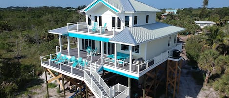 Beach view of house. Shows sundecks and lanai.