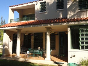 View from the backyard to patio and balcony- plenty of space for outdoor dining.