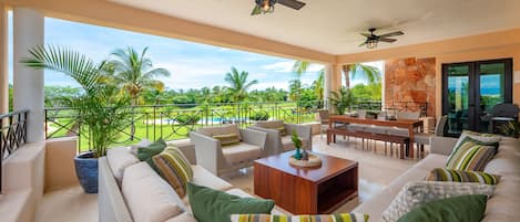 Beautiful terrace over looks the pool, grass area and the Bahia Golf Course