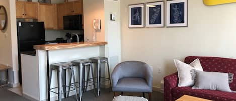 Bar seating area adjacent to living room