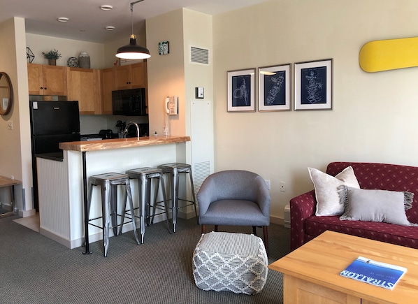 Bar seating area adjacent to living room