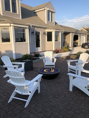 Front patio with gas fire bowl and adirondack chairs.