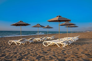 Private sun beds at the sandy beach of Rethymno, just 100 meters from the Villa.