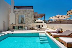 Comfortable sun beds, a day bed and umbrellas are available by the pool!