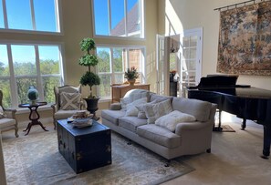 Formal living room with vaulted ceilings and Yamaha grand piano.