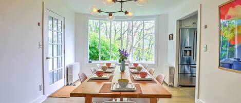 Dining room table with bay window.