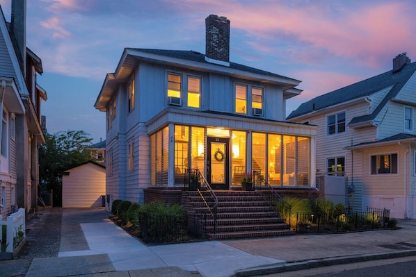 UPDATED IMAGE! Front view of house, screened in front porch