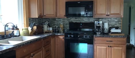 Clean and well-stocked 1st floor kitchen with sunny southern exposure. 