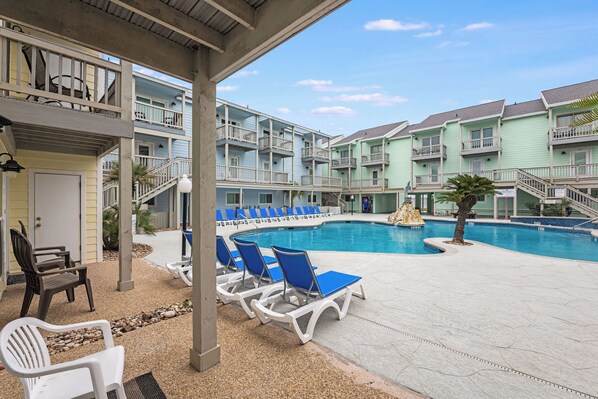 Relax on the patio with a picturesque view overlooking the sparkling pool—a perfect spot to unwind and enjoy the outdoors