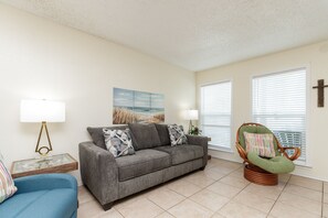 Bright and airy living space filled with natural light in this convenient poolside retreat