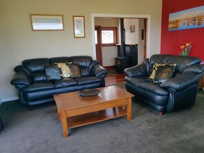Open plan lounge with two leather couches.