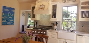 Kitchen is anchored by this excellent Viking gas stove and the huge pine table
