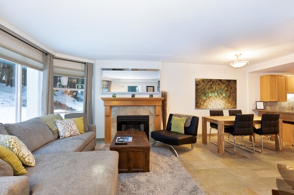 Living area with large picture windows and cozy gas fireplace