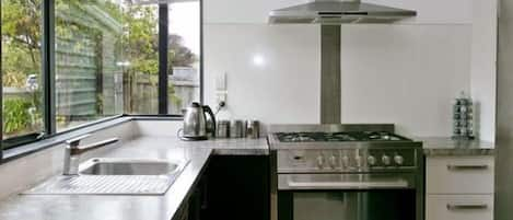 Modern kitchen, fully equipped with dishes, cutlery, pots and pans etc